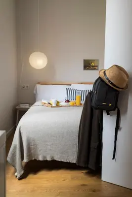 a bedroom with a bed with a backpack on it at Bed&BCN Diagonal 4 in Barcelona