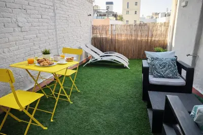 a sculpture on the grass next to a building at Poblenou Beach Penthouse l Loft with Private Terrace l 5 min Walk to the Beach in Barcelona