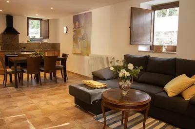a living room with a couch and a table at Mas Cal Gira in Moià