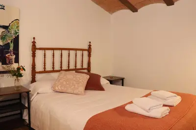 a bedroom with a bed with two towels on it at Mas Cal Gira in Moià
