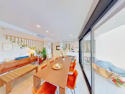 a dining room and living room with a table and chairs at Premium Habitat 3 Hermanas in Sant Andreu de Llavaneres