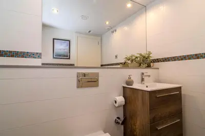 a bathroom with a sink and a mirror at Sitges Spaces Sea View Oasis in Sitges