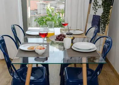 a glass table with plates of food and glasses of wine at Sitges Spaces Sea View Oasis in Sitges