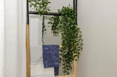 a plant hanging from a towel rack next to a window at Sitges Spaces Sea View Oasis in Sitges