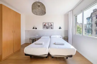 a room with a bed and a phone on the wall at BeBarceloner Eixample Apartments - 4 bedrooms in Barcelona