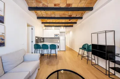 a hallway with a sliding glass door and paintings on the wall at BeBarceloner Eixample Apartments - 4 bedrooms in Barcelona