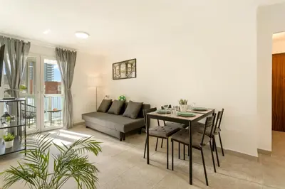 a living room with a table and a couch at Apartamento cerca de la playa in Barcelona