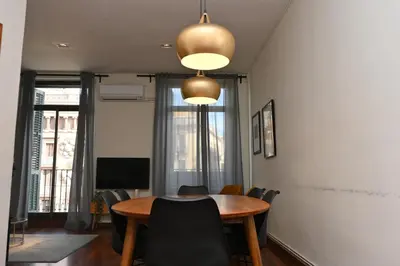 a dining room with a table and chairs at Homenfun Barcelona Las Ramblas in Barcelona