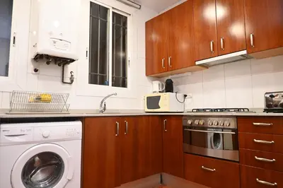 a kitchen with a washer and a washing machine at Homenfun Barcelona Las Ramblas in Barcelona