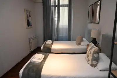two beds in a hotel room with two beds at Homenfun Barcelona Las Ramblas in Barcelona