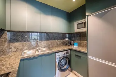 a kitchen with a sink and a washing machine at Sweett - Casa Roma in Barcelona