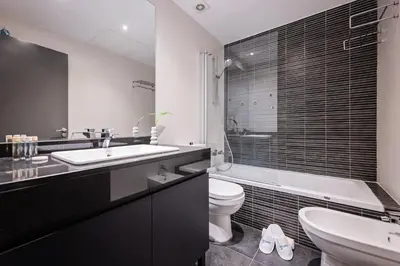 a black and white bathroom with a sink and a toilet at Sweett - Casa Roma in Barcelona