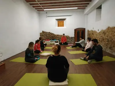 a group of people sitting in a yoga class at Mas Can Puig de Fuirosos ONLY ADULTS in La Batlloria