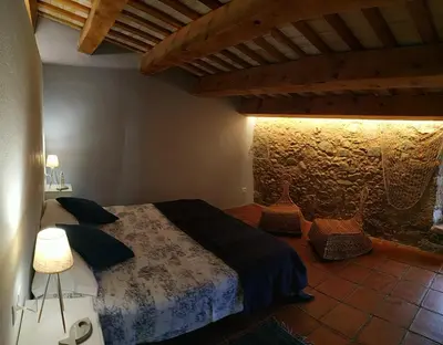a bedroom with a bed in a room at Mas Can Puig de Fuirosos ONLY ADULTS in La Batlloria
