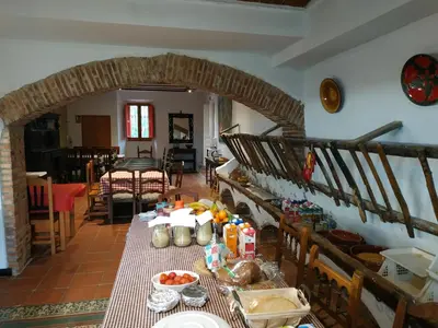 a living room with a table with food on it at Mas Can Puig de Fuirosos ONLY ADULTS in La Batlloria