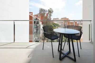 a table and chairs on a balcony with a view at Numa Barcelona Colmena in Barcelona