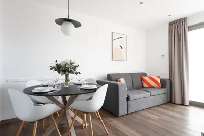 a living room with a table and a couch at Numa Barcelona Colmena in Barcelona