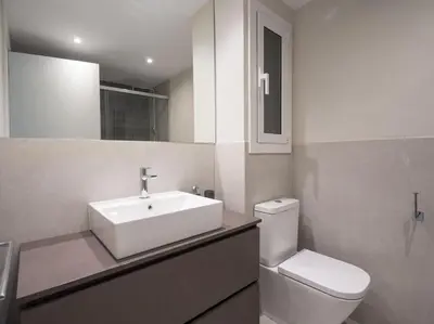 a bathroom with a white sink and a toilet at Sitges Spaces Deluxe Comfort Flat-Monthly Rentals in Sitges