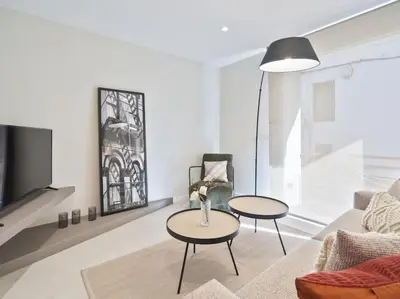 a living room with two tables and a couch at Sitges Spaces Deluxe Comfort Flat-Monthly Rentals in Sitges