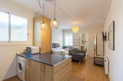 a kitchen and living room with a washer and dryer at BeBarceloner Sant Andreu Apartments - Studio in Barcelona