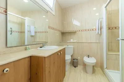 a bathroom with a sink and a toilet and a mirror at BeBarceloner Sant Andreu Apartments - Studio in Barcelona