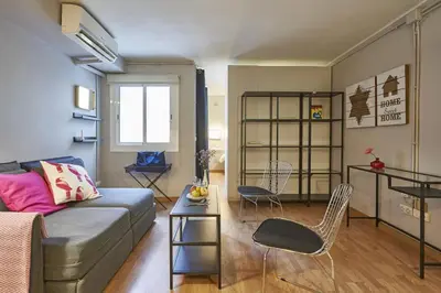a living room with a couch and a table at BeBarceloner Sant Andreu Apartments - 1 bedroom in Barcelona