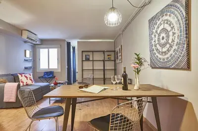 a living room with a table with chairs and a couch at BeBarceloner Sant Andreu Apartments - 1 bedroom in Barcelona