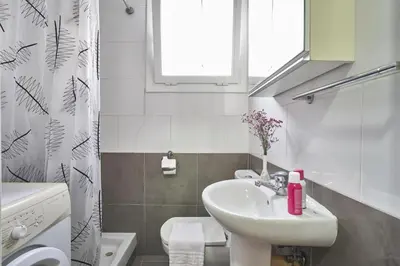 a bathroom with a sink and a toilet and a window at BeBarceloner Sant Andreu Apartments - 1 bedroom in Barcelona