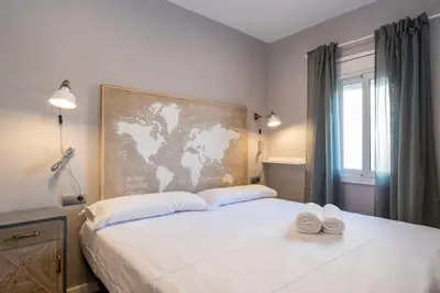 a bedroom with a large bed with two towels on it at BeBarceloner Sant Andreu Apartments - 3 bedrooms with terrace in Barcelona