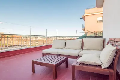 a couch and a coffee table on a balcony at BeBarceloner Sant Andreu Apartments - 3 bedrooms with terrace in Barcelona