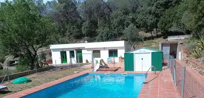 a house with a swimming pool next to a building at Cottage Eco-Friendly Barcelona country side in La Garriga
