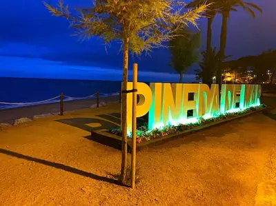 a sign that is lit up at night at Apart. Pineda de Mar-Sea and mountains views in Pineda de Mar