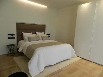 a bedroom with a large bed with white sheets and pillows at HOTEL MANEL in Martorell