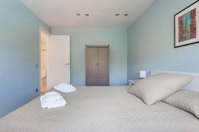 a bedroom with a bed with two towels on it at HHBCN Beach Apartment Castelldefels #3 in Castelldefels