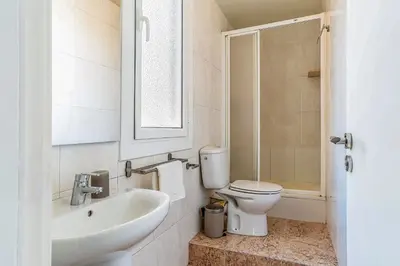 a bathroom with a sink and a toilet and a mirror at AB Nou de la Rambla in Barcelona