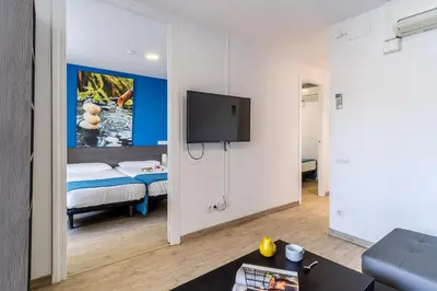 a living room with a tv on a wall at AB Nou de la Rambla in Barcelona