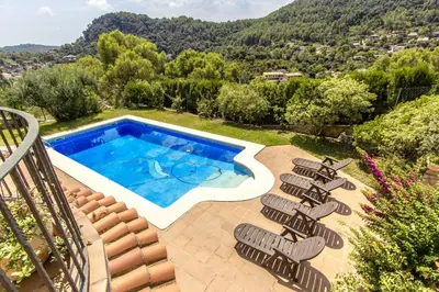 a group of lounge chairs next to a swimming pool at Catalunya Casas Spacious, Sublime Villa just 15km to Barcelona! in Torrelles de Llobregat