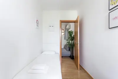 a hallway with a door leading into a room at The Collection Barcelona - Sunny 3BD only for Families in Poblenou next to the sea! in Barcelona