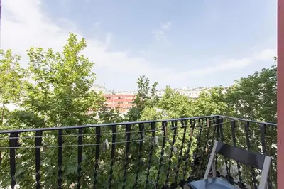 a balcony with a black railing and trees at The Collection Barcelona - Sunny 3BD only for Families in Poblenou next to the sea! in Barcelona