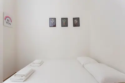 a white room with a bed with three pictures on the wall at The Collection Barcelona - Poblenou only for Families 3BD next to the beach! in Barcelona
