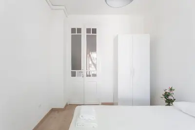 a white bedroom with a bed and a closet at The Collection Barcelona - Poblenou only for Families 3BD next to the beach! in Barcelona
