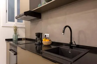 a kitchen with a sink and a bowl of oranges at The Collection Barcelona - Poblenou only for Families 3BD next to the beach! in Barcelona