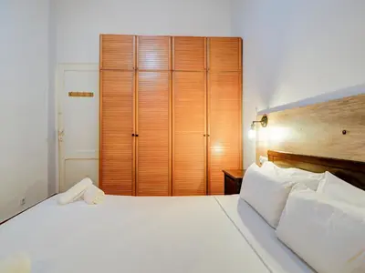 a bedroom with a large white bed and a large closet at Charming Patio by Hello Homes Sitges in Sitges