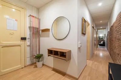 a hallway with a mirror on a wall at Stay U-nique Apartment Maurici Serrahima in Barcelona