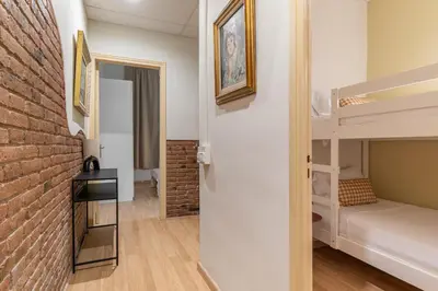 a room with a brick wall and bunk beds at Stay U-nique Apartment Maurici Serrahima in Barcelona