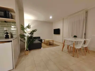 a living room with a table and a couch at Mazi Apartments Havana in Mataró