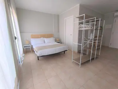a bedroom with a bed and a book shelf at Mazi Apartments Havana in Mataró
