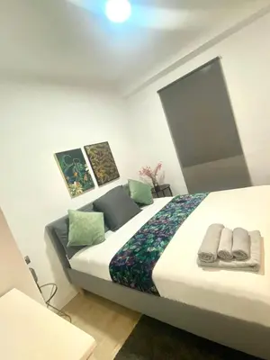 a bedroom with a large bed with towels on it at Barcelona Chic Apartments- Free Parking - 10 min BCN center by metro in Barcelona