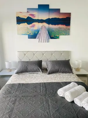 a bedroom with a bed with two pillows at Beach Apartment Artigas in Badalona