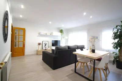 a living room with a couch and a table at Nice new apartment only 30min to Barcelona center. in Granollers